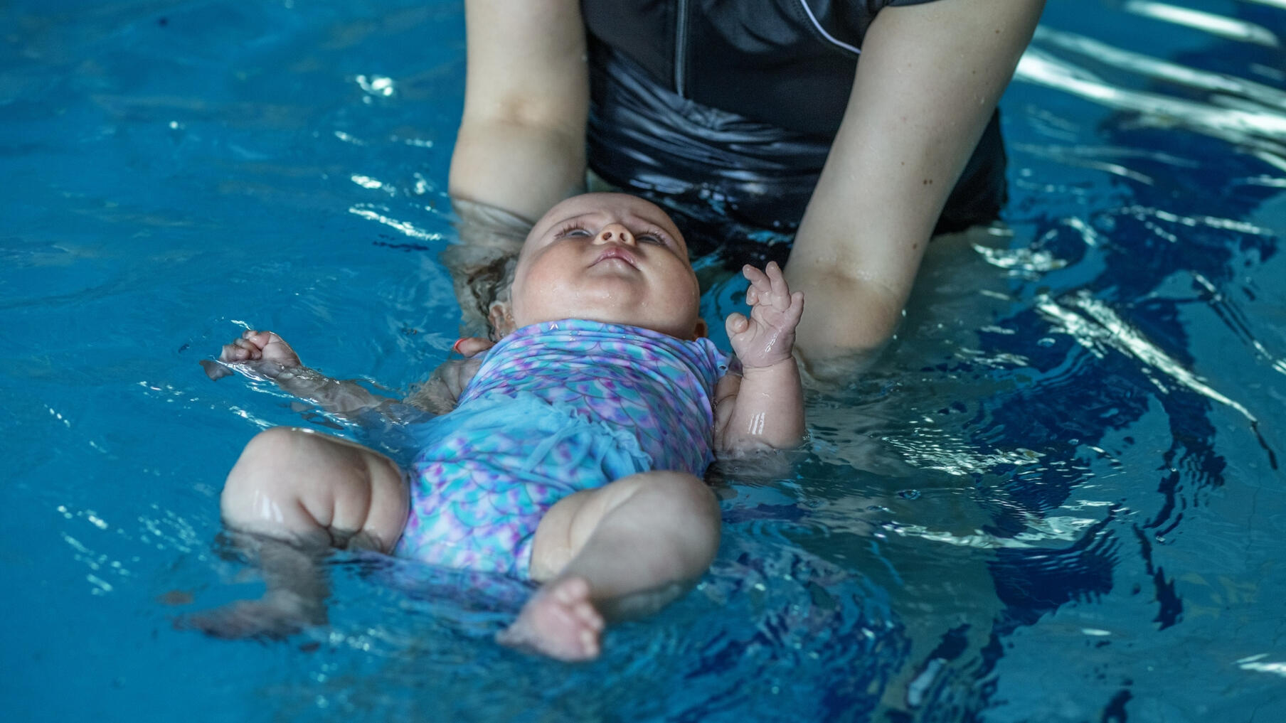 Baby Group Swimming Woman coaching baby swimming classes