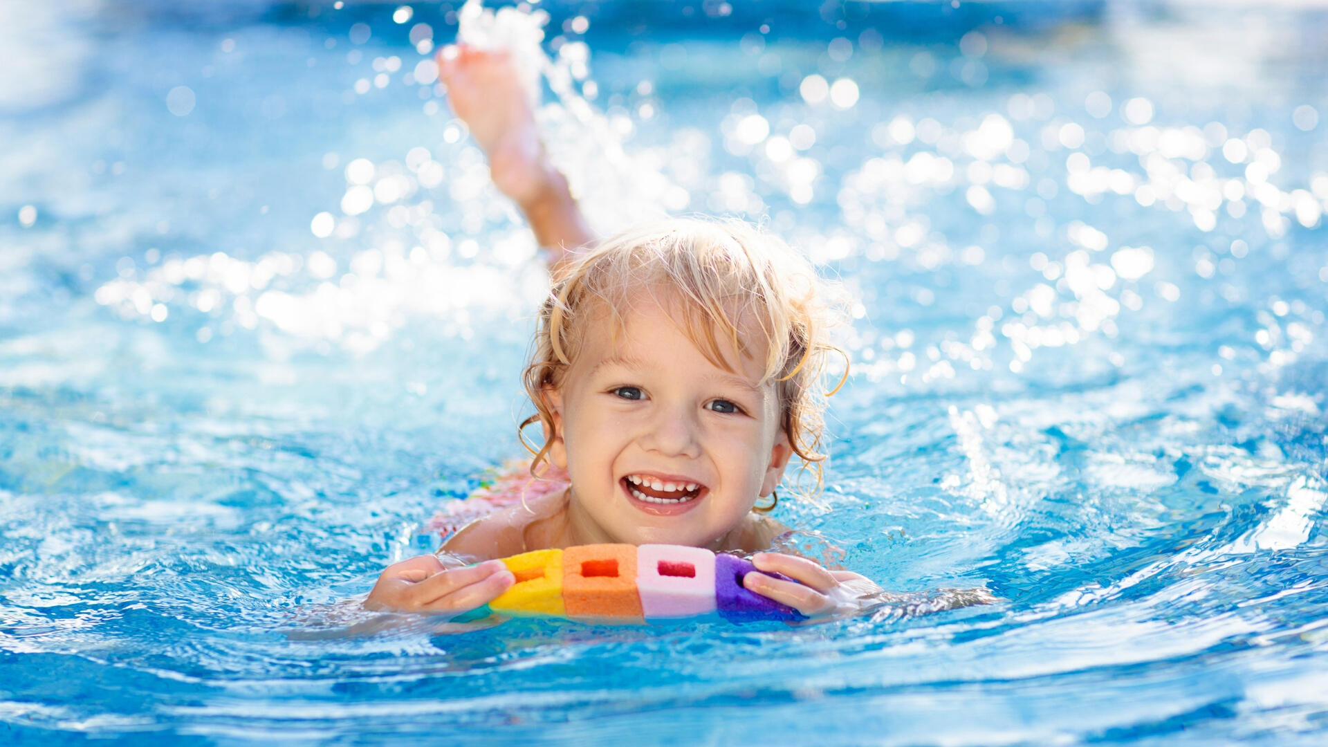 Child having fun during swimming lessons